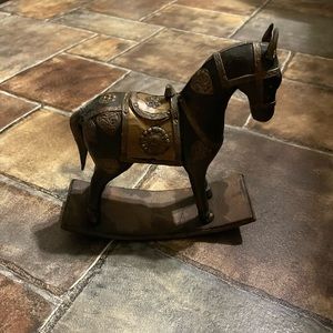 Solid wood rocking horse with gold plated embellishments.